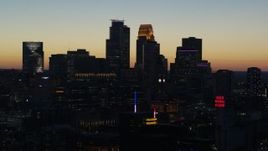5.7K aerial stock footage passing skyscrapers lit for night in the city skyline at twilight, Downtown Minneapolis, Minnesota Aerial Stock Footage | DX0001_002577
