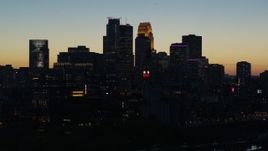 5.7K aerial stock footage pass skyscrapers lit for night in the city skyline at twilight during descent, Downtown Minneapolis, Minnesota Aerial Stock Footage | DX0001_002578