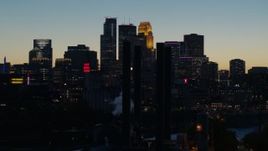 5.7K aerial stock footage flyby smoke stacks and the city skyline lit for the night at twilight, Downtown Minneapolis, Minnesota Aerial Stock Footage | DX0001_002583