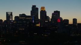 5.7K aerial stock footage focus on the city skyline lit for the night at twilight, Downtown Minneapolis, Minnesota Aerial Stock Footage | DX0001_002586