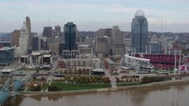 5.7K aerial stock footage ascend and fly away from city skyline and baseball stadium by Ohio River, Downtown Cincinnati, Ohio Aerial Stock Footage | DX0001_002596