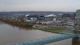 5.7K aerial stock footage fly over bridge spanning river to approach football stadium, Downtown Cincinnati, Ohio Aerial Stock Footage | DX0001_002611
