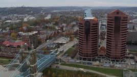5.7K aerial stock footage of two riverfront office buildings during descent by bridge in Covington, Kentucky Aerial Stock Footage | DX0001_002623