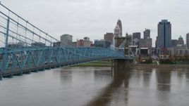 5.7K aerial stock footage ascend from river beside the bridge with the city skyline in background, Downtown Cincinnati, Ohio Aerial Stock Footage | DX0001_002633