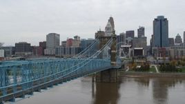 5.7K aerial stock footage fly over Ohio River beside the bridge toward the city skyline, Downtown Cincinnati, Ohio Aerial Stock Footage | DX0001_002634