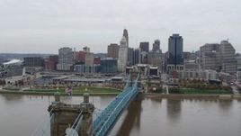 5.7K aerial stock footage fly close to the Roebling Bridge and away from the city skyline, Downtown Cincinnati, Ohio Aerial Stock Footage | DX0001_002637