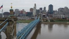 5.7K aerial stock footage fly close to the Roebling Bridge spanning Ohio River near the city skyline, Downtown Cincinnati, Ohio Aerial Stock Footage | DX0001_002638