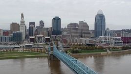 5.7K aerial stock footage flyby the city's downtown skyline, seen from bridge spanning Ohio River, Downtown Cincinnati, Ohio Aerial Stock Footage | DX0001_002649
