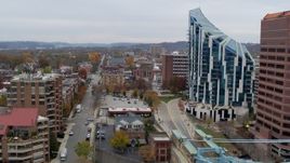 5.7K aerial stock footage ascend by city street with view of condo complex in Covington, Kentucky Aerial Stock Footage | DX0001_002655