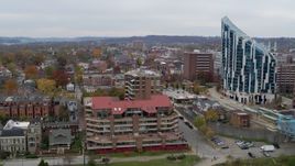 5.7K aerial stock footage ascend by riverfront condo complex for view of brick buildings in Covington, Kentucky Aerial Stock Footage | DX0001_002658