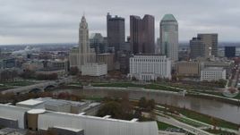 5.7K aerial stock footage of flying by the city's skyline across the Scioto River, Downtown Columbus, Ohio Aerial Stock Footage | DX0001_002718
