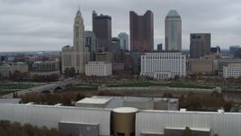 5.7K aerial stock footage of passing by Discovery Bridge and Scioto River by city skyline, Downtown Columbus, Ohio Aerial Stock Footage | DX0001_002721