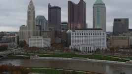 5.7K aerial stock footage reverse view of river and city skyline, reveal the science museum, Downtown Columbus, Ohio Aerial Stock Footage | DX0001_002726