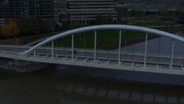 5.7K aerial stock footage reverse view of the Main Street Bridge spanning the Scioto River at sunset, Downtown Columbus, Ohio Aerial Stock Footage | DX0001_002738