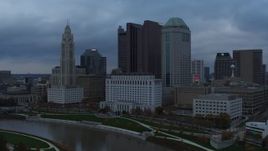5.7K aerial stock footage city skyline on the other side of the Scioto River at sunset, Downtown Columbus, Ohio Aerial Stock Footage | DX0001_002739