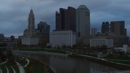 5.7K aerial stock footage flyby the city skyline and the Scioto River at sunset during descent, Downtown Columbus, Ohio Aerial Stock Footage | DX0001_002748