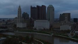 5.7K aerial stock footage stationary view of the city skyline and the Scioto River at sunset, Downtown Columbus, Ohio Aerial Stock Footage | DX0001_002750