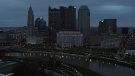 5.7K aerial stock footage of flying by Scioto River and then approach city skyline at sunset, Downtown Columbus, Ohio Aerial Stock Footage | DX0001_002755