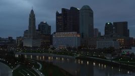 5.7K aerial stock footage of the city skyline by the Scioto River seen from museum at sunset, Downtown Columbus, Ohio Aerial Stock Footage | DX0001_002759