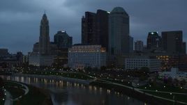 5.7K aerial stock footage of the city skyline and the Scioto River at sunset, Downtown Columbus, Ohio Aerial Stock Footage | DX0001_002760