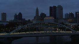 5.7K aerial stock footage flying by bridge with the city skyline in the background at twilight, Downtown Columbus, Ohio Aerial Stock Footage | DX0001_002770