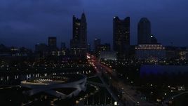 5.7K aerial stock footage of passing by the city skyline across the bridge and river at twilight, Downtown Columbus, Ohio Aerial Stock Footage | DX0001_002775