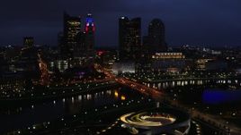 5.7K aerial stock footage of a bridge spanning the river and city skyline at twilight, Downtown Columbus, Ohio Aerial Stock Footage | DX0001_002790