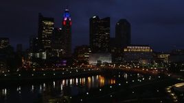 5.7K aerial stock footage reverse view of a bridge spanning the river and city skyline at twilight during descent, Downtown Columbus, Ohio Aerial Stock Footage | DX0001_002792
