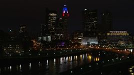 5.7K aerial stock footage of LeVeque Tower and bridge spanning the river at night seen during descent, Downtown Columbus, Ohio Aerial Stock Footage | DX0001_002804