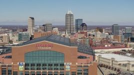 5.7K aerial stock footage of flying by the football stadium, with the skyline in the background in Downtown Indianapolis, Indiana Aerial Stock Footage | DX0001_002825