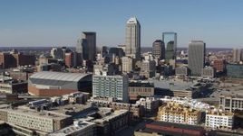 5.7K aerial stock footage flying by the city's skyline near the arena in Downtown Indianapolis, Indiana Aerial Stock Footage | DX0001_002849