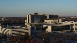 5.7K aerial stock footage of flying by a hospital complex at sunset in Indianapolis, Indiana Aerial Stock Footage | DX0001_002915