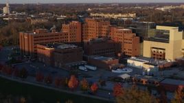 5.7K aerial stock footage pass and fly away from a VA hospital complex at sunset in Indianapolis, Indiana Aerial Stock Footage | DX0001_002920