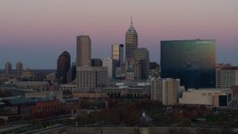 5.7K aerial stock footage of ascending near city's skyline and hotel at sunset, Downtown Indianapolis, Indiana Aerial Stock Footage | DX0001_002944