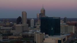 5.7K aerial stock footage of a reverse view of a hotel at sunset, and then flyby skyline in Downtown Indianapolis, Indiana Aerial Stock Footage | DX0001_002946