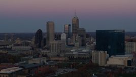 5.7K aerial stock footage flying by the city's skyline and a hotel at sunset in Downtown Indianapolis, Indiana Aerial Stock Footage | DX0001_002948