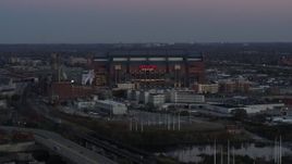 5.7K aerial stock footage reverse view and flyby of a football stadium at sunset, Downtown Indianapolis, Indiana Aerial Stock Footage | DX0001_002954