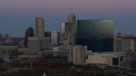 5.7K aerial stock footage slow pass by hotel at twilight, Downtown Indianapolis, Indiana skyline in background Aerial Stock Footage | DX0001_002956