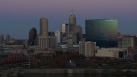 5.7K aerial stock footage of flying by hotel at twilight in Downtown Indianapolis, Indiana skyline in background Aerial Stock Footage | DX0001_002957