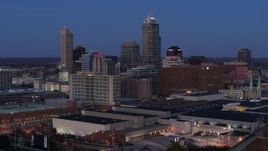 5.7K aerial stock footage fly away from and past city skyline at twilight to reveal smoke stacks, Downtown Indianapolis, Indiana Aerial Stock Footage | DX0001_002961