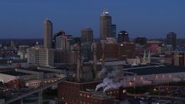 5.7K aerial stock footage fly past smoke stacks at twilight with skyline in background, Downtown Indianapolis, Indiana Aerial Stock Footage | DX0001_002962
