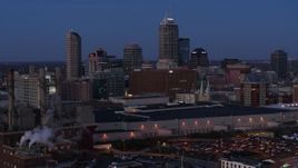 5.7K aerial stock footage slowly pass smoke stacks at twilight with skyline in background, Downtown Indianapolis, Indiana Aerial Stock Footage | DX0001_002963