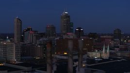5.7K aerial stock footage flyby giant skyscrapers of the city skyline at twilight, reveal smoke stacks, Downtown Indianapolis, Indiana Aerial Stock Footage | DX0001_002970