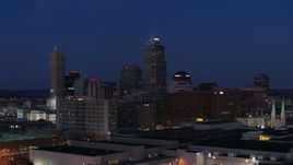 5.7K aerial stock footage flyby giant skyscrapers of the city skyline at twilight, reveal smoke stacks, Downtown Indianapolis, Indiana Aerial Stock Footage | DX0001_002974