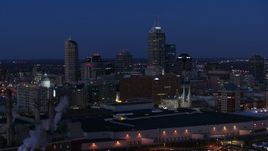5.7K aerial stock footage flyby smoke stacks and skyscrapers of the city skyline at twilight, Downtown Indianapolis, Indiana Aerial Stock Footage | DX0001_002975