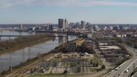 5.7K aerial stock footage passing by the river with view of the city's skyline in Downtown Louisville, Kentucky Aerial Stock Footage | DX0001_002998