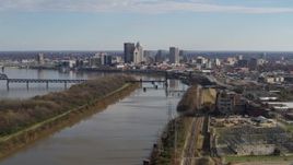 5.7K aerial stock footage of the city's skyline seen while flying by the river in Downtown Louisville, Kentucky Aerial Stock Footage | DX0001_002999