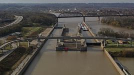 5.7K aerial stock footage flying by locks and a dam on the Ohio River in Louisville, Kentucky Aerial Stock Footage | DX0001_003012