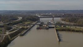 5.7K aerial stock footage reverse view of locks and a dam on the Ohio River in Louisville, Kentucky Aerial Stock Footage | DX0001_003013