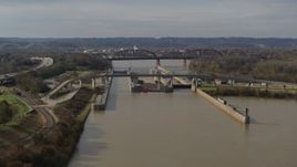 5.7K aerial stock footage descend near locks and a dam on the Ohio River in Louisville, Kentucky Aerial Stock Footage | DX0001_003014